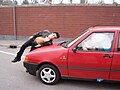 A collison in Italy between a person and an old Fiat Uno,