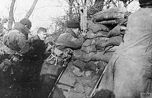 A sergeant of 'D' Company, 1st Battalion, Royal Scots, using a trench periscope to observe German trenches near Kemmel in January 1915 The 1st Battalion, Royal Scots in the Ypres Salient, 1915 Q50338.jpg