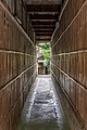 View from a pedestrian tunnel with bamboo walls and symmetrical centered perspective, Higashiyama-ku, Kyoto, Japan.jpg