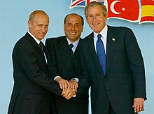 Putin with Italian prime minister Silvio Berlusconi and U.S. president George W. Bush at the NATO-Russia Council meeting in Rome on 28 May 2002 Vladimir Putin 28 May 2002-13.jpg