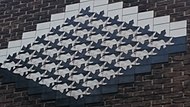 afbeelding van Escher's bekende werk 'Vogels en vissen' - hier als als muurdecoratie aan de gevel van Dirk Schäferstraat 59, Amsterdam
