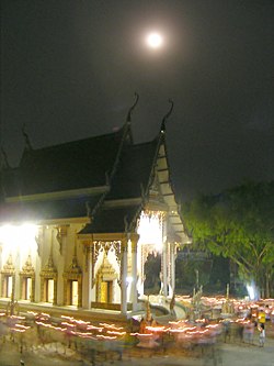 Circumambulation around a temple or a stupa is also a common devotional practice. Walk with lighted candles in hand around a temple.jpg