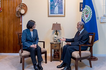 Governor-General Sir Colville Young and President Tsai of Taiwan converse under a portrait of Queen Elizabeth II, 2018