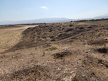 The archeological site of Bakr Awa, an ancient mound near Halabja, Iraq. November 4, 2022. The tell and its surrounding area were lastly excavated in 2014. An area before the tell; note the numerous looters' pits. 105. The archeological site of Bakr Awa, an ancient mound near Halabja, Shahrizor Plain, Sulaymaniyah, Iraq. November 4, 2022. The tell and its surrounding area were lastly excavated in 2014. An area before the tell.jpg