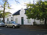 These properties were granted in 1750 to the landdrost and Heemrade, and to Jan Greyling. The complex of buildings is of special architectural interest and forms an essential part of the historic core of Stellenbosch. 21 Herte Street, Stellenbosch.JPG