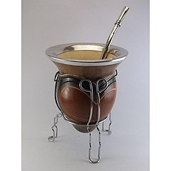 Calabash used as a container for drinking mate with a metal bombilla.