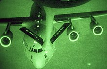 A C-17 Globemaster III receives fuel from a KC-135 during night operations. A KC-135 Stratotanker from the 127th Air Refueling Group performs a night time refueling for a C-17 Globemaster III.jpg