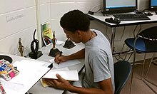 An Albany State student prepares for the qualifying tournament next to past trophies earned by his institution. AlbanyStateUniv HCASC.jpg