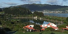 The southbound Capital Connection passes Aotea Lagoon and the southern arm of Porirua Harbour as it approaches Porirua.