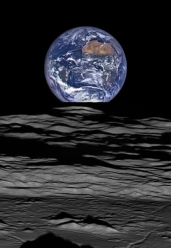 The Earth straddling the limb of the Moon, as seen from above Compton crater. Taken by the Lunar Reconnaissance Orbiter in 2015.