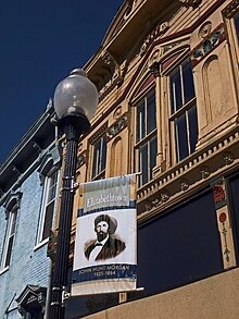 A banner remembers John Hunt Morgan's role in the history of Elizabethtown, KY. A Confederate cannonball is imbedded in the blue building at left (the ball is visible just below and to the left of the nearest second-story window). Elizabethtown KY.jpg