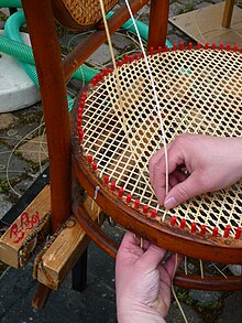 A chair being caned. Flechten Sitzflache Stuhl.JPG