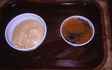 Fufu (left) and palm nut soup (right). Fufu-palmnutsoup.jpg