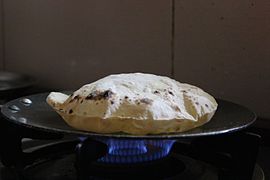 A roti being baked on a tava