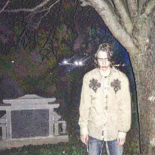 Ghost Mountain standing in front of a graveyard (2019-2020?)