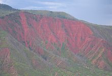 Reddish colored sandstone cliffs surround the city. GlenwoodCO.JPG