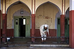 Muslim man washing in front of mosque India Delhi