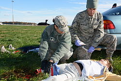 Lt. Col. Mildred Pagan-Perez (left) and Staff Sgt. Mark Metzelaar, 512th Aerospace Medicine Squadron, simulate first response treatment of a Delaware Civil Air Patrol cadet Sam Rundle during a training exercise. Lt. Col. Mildred Pagan-Perez (left) and Staff Sgt. Mark Metzelaar treat Delaware CAP cadet.JPG