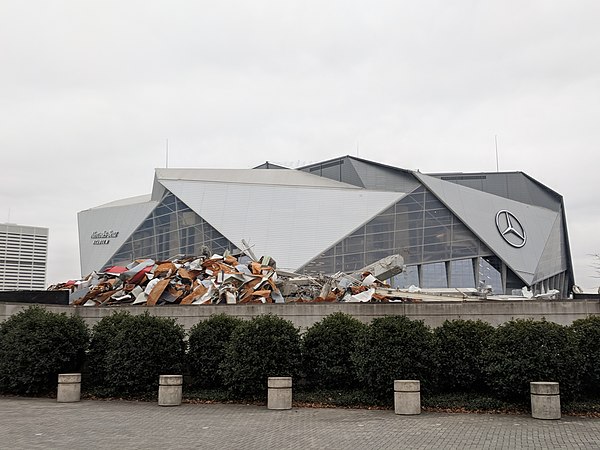 The remains of the Dome with Mercedes-Benz Stadium in the background.