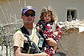 A Kurdish Peshmerga fighter holding his daughter in their village outside of Dahuk.