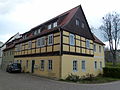 House in a corner, with a massive extension to the rear