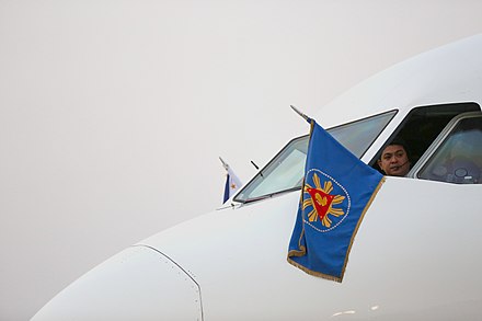 The flag of the Philippine president, which contains the coat of arms of the president, is hoisted outside the cockpit of Philippine Airlines Flight PR001 during President Rodrigo Duterte's official visit to Myanmar in March 2017.