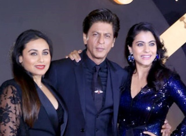 Kajol with Rani Mukerji (left) and Khan at an event for Kuch Kuch Hota Hai in 2018