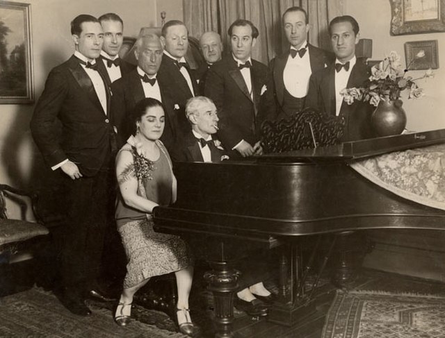 Maurice Ravel at the piano with Éva Gauthier in 1928; George Gershwin listens at right.