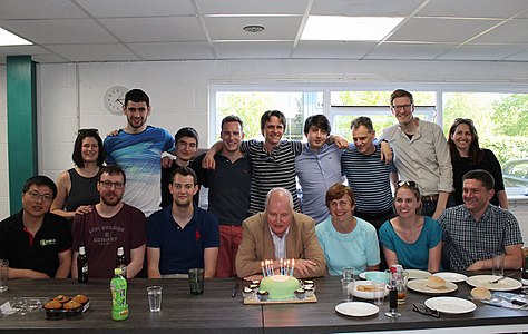 A RepRap 10th Birthday celebration: Left to right back row: Bonnie (earliest E3D employee), Torbjørn Ludvigsen (maker of Hangprinter), E3D Online founders Dave Lamb, Joshua Rowley and Sanjay Mortimer, Chris Palmer (nophead Mendel 90), Christian, Clare Difazio. Left to right front row: Rongsheng Zhang (RepRapPro China), Greg Holloway (toolchanger and BigBox), Rory (E3D engineer), Adrian Bowyer, Mary, Sally Bowyer (Director of RepRapLtd) and Richard Horne.