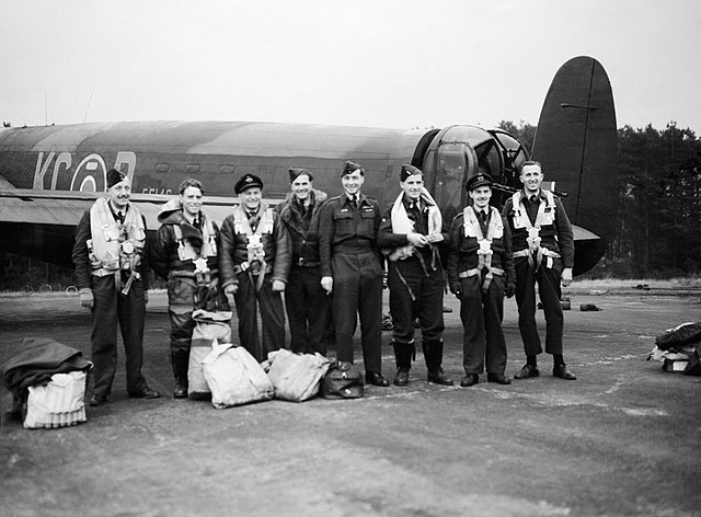 No. 617 Squadron Avro Lancaster B.I EE146 at RAF Woodhall Spa with her crew (including OC Wg. Cdr. J. B. Tait) the day after the successful attack aga