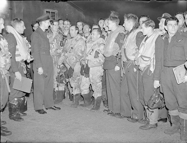 Wing Commander F R Jeffs, OC No. 207 Squadron RAF, wishes his aircrews good luck at RAF Syerston, before they board their aircraft for a night raid on
