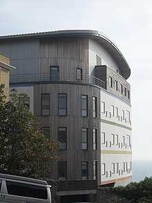 The curved building has sea views and windows at "child height". Royal Alexandra Children's Hospital (New Building), Brighton (from northwest).jpg