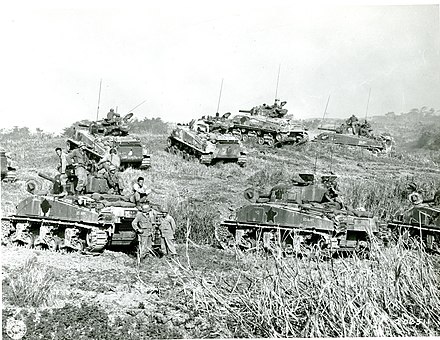 A platoon of Sherman tanks of the 713th Tank Battalion gathered at a ridge on Okinawa.