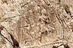 Sarpol-e Zahab, relief I. Beardless warrior with axe, trampling a foe. Sundisk above. A name "Zaba(zuna), son of ..." can be read. He is usually considered as a ruler of the Lullubi,[48][49] but he could be a ruler of the Kingdom of Simurrum, son of Iddin-Sin.[7]