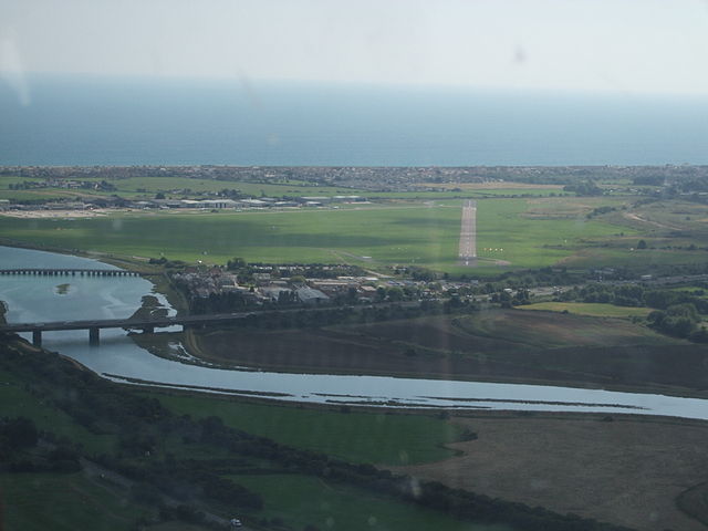 Aerial view looking south-west towards Shoreham airport. The aircraft hit the A27 dual-carriageway between the River Adur, in the foreground, and the 