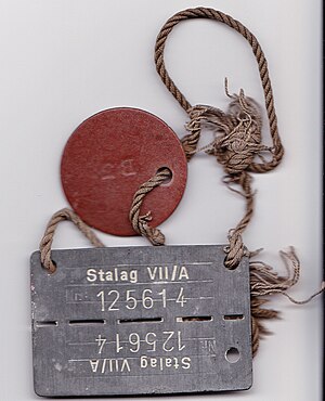 ID tag as worn by POWs. Name and service number are on the brown disc.