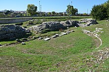 1st century Roman Theatre in Salona, Dalmatia The Roman Theatre with semicircular auditorium (cavea) and two tiers of seats that could accommodate 3,000 spectators, built in the mid-1st century AD, Salona, Dalmatia (12287600613).jpg