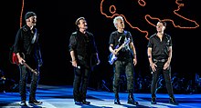 U2 during the Joshua Tree Tour 2019, the last time they performed live before Sphere. Drummer Larry Mullen Jr. (right) was absent from the residency in order to recuperate from surgery. U2 in Sydney (49121965382).jpg