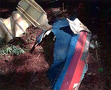 Debris of Flight 93 found at crash site. The United Airlines "Battleship Gray" livery used on the aircraft is visible. UA93 livery debris.jpg