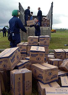 Sailors of USS Abraham Lincoln prepare for aerial resupply drops by US helicopters. US Navy 050102-N-9593M-088 Sailors, assigned to USS Abraham Lincoln (CVN 72) and embarked Carrier Air Wing Two (CVW-2), move supplies from a truck in preparation for aerial resupply drops by SH-60 Seahawk helicopters.jpg