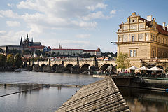 Cafe by waterfront Vltava River and the Charles Bridge, Prague, Czech Republic