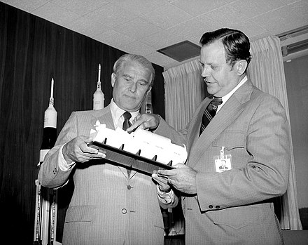 Von Braun and William R. Lucas, the first and third Marshall Space Flight Center directors, viewing a Spacelab model in 1974; von Braun's proposals for the development of astronautics were not accepted, and priority was given to the space shuttle program instead