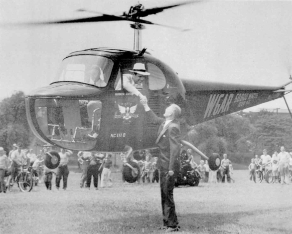 WGAR's Wayne Mack (in the helicopter) shaking the hand of a Canton, Ohio, dignitary as part of the station's 1947 Hometown Ohio series heralding their upgrade to 50,000 watts.