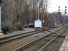 Former junction of the Woburn Branch Railroad (left) and the Boston & Lowell Railroad (now the MBTA Lowell Line) in Winchester in 2013 Winchester interlocking (former Woburn Branch junction).JPG