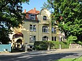 Double tenement house with fencing in open development