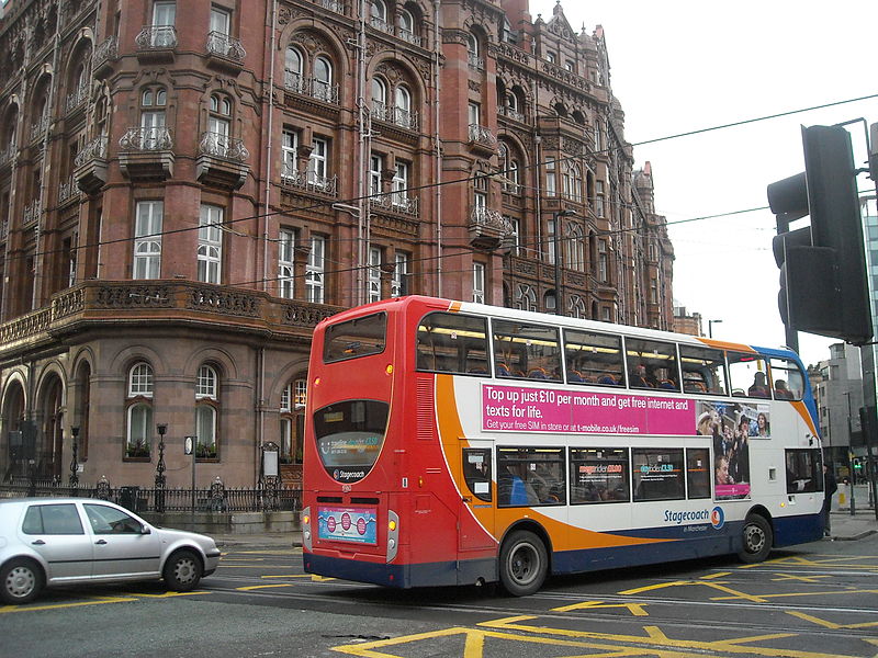 File:A bus crossing over the tram lines.jpg