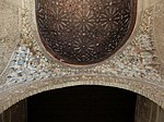 Ceiling of the hall: a rounded wooden vault, transitioning through muqarnas to the arch of the side alcove