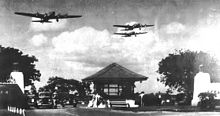 Boeing B-17D Fortresses of the 5th Bombardment Group overfly the main gate at Hickam Field, Hawaii Territory during the summer of 1941. 21 B-17C/Ds had been flown out to Hawaii during May to reinforce the defenses of the islands.