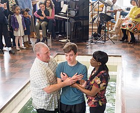 Believer's baptism of adult by immersion at Northolt Park Baptist Church, in Greater London, Baptist Union of Great Britain, 2015. Baptism at Northolt Park Baptist Church (cropped).jpg