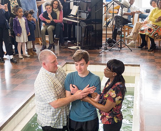 Believer's baptism of adult by immersion at Northolt Park Baptist Church, in Greater London, Baptist Union of Great Britain.